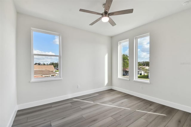 empty room with wood-type flooring and ceiling fan