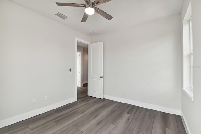 spare room with ceiling fan and hardwood / wood-style flooring