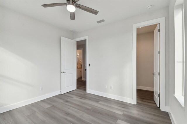 unfurnished bedroom featuring ceiling fan and light hardwood / wood-style flooring