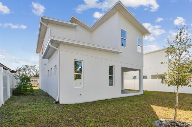 back of property featuring a yard