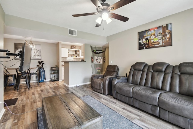 living room with ceiling fan and hardwood / wood-style flooring