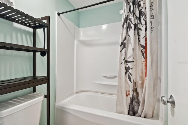 bathroom featuring toilet and shower / tub combo with curtain