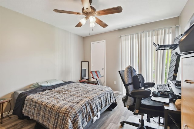 bedroom with ceiling fan and dark hardwood / wood-style floors