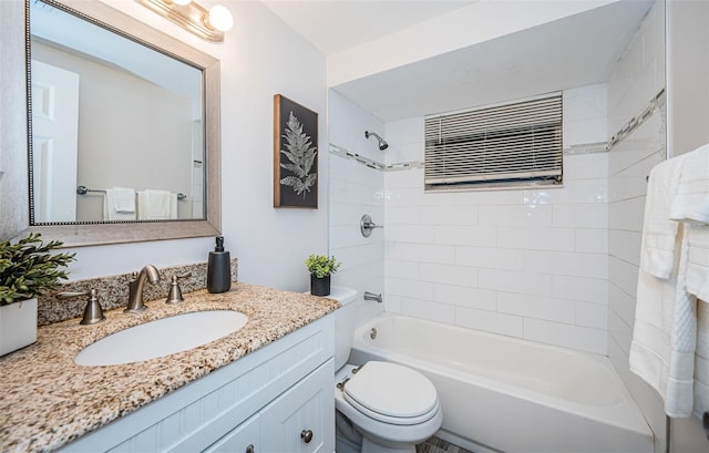 full bathroom featuring vanity, tiled shower / bath combo, and toilet