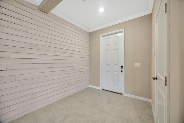 interior space with wooden walls, baseboards, and crown molding