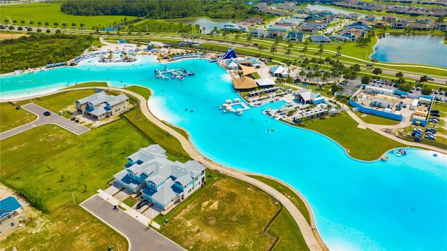 drone / aerial view with a water view and a beach view