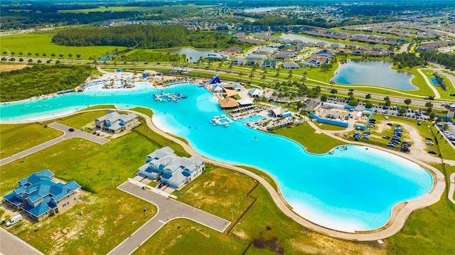 birds eye view of property with a water view and a view of the beach