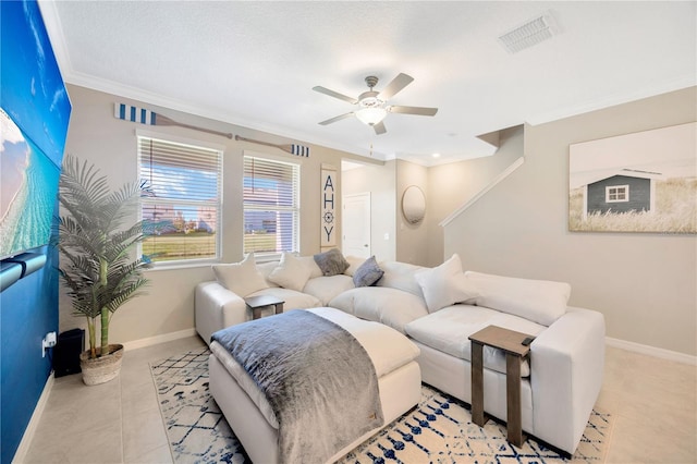 tiled living room with ceiling fan, ornamental molding, and a textured ceiling