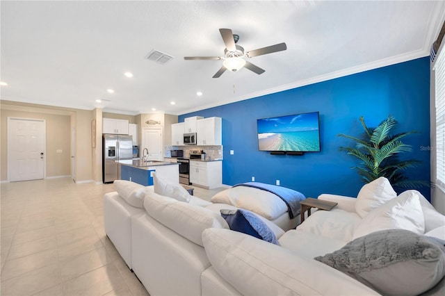 living room with crown molding, light tile patterned floors, and ceiling fan