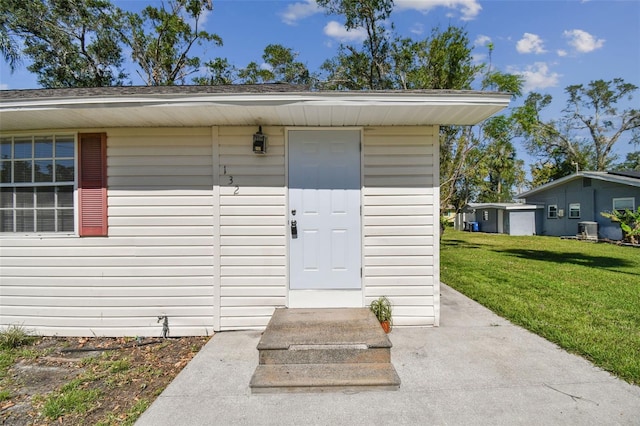 doorway to property featuring a yard