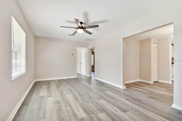 spare room featuring ceiling fan, a textured ceiling, and light wood-type flooring