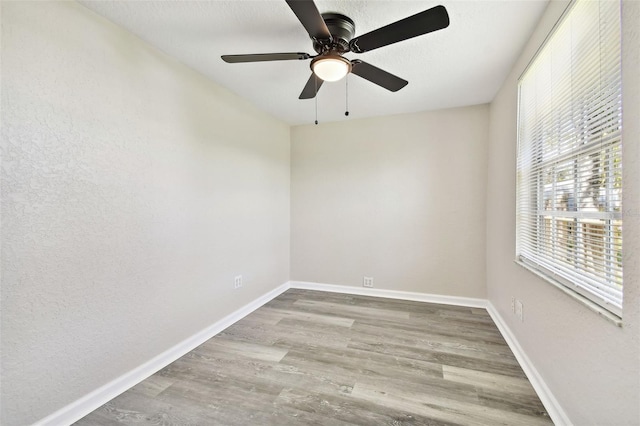 unfurnished room featuring light hardwood / wood-style flooring and ceiling fan