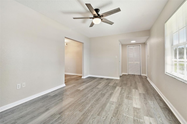 spare room featuring light hardwood / wood-style flooring and ceiling fan