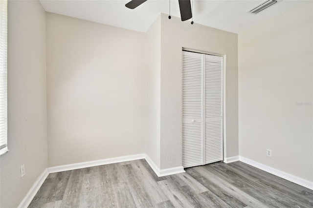 unfurnished bedroom featuring a closet, ceiling fan, and hardwood / wood-style flooring