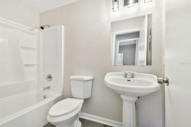 bathroom featuring hardwood / wood-style floors, toilet, and shower / bathtub combination