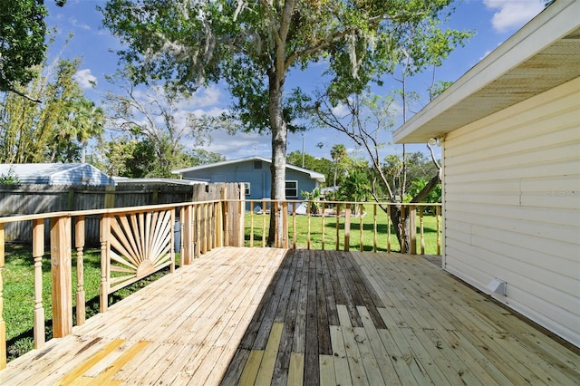 wooden deck with a lawn