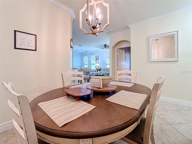 dining space featuring ornamental molding, ceiling fan with notable chandelier, and light tile patterned floors