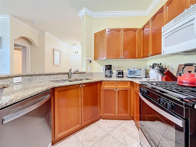 kitchen with stainless steel appliances, sink, crown molding, light stone countertops, and light tile patterned floors