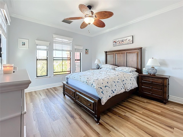 bedroom featuring light hardwood / wood-style flooring, ornamental molding, and ceiling fan