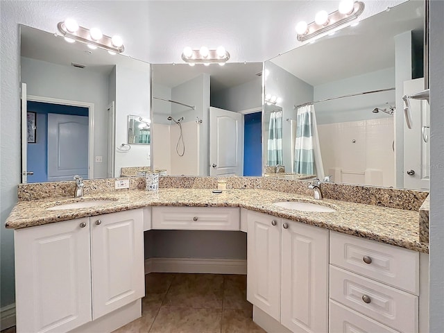 bathroom featuring vanity, curtained shower, and tile patterned floors