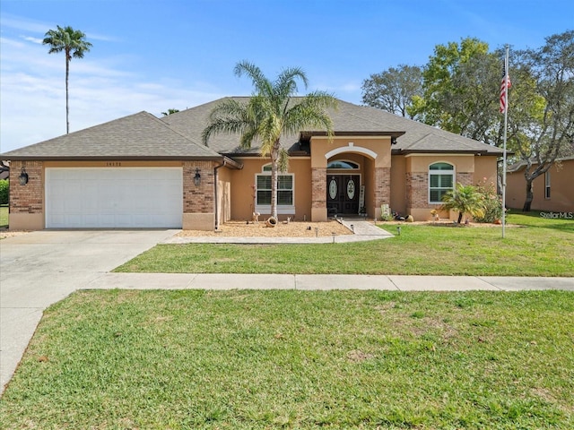 view of front of property featuring a front yard and a garage