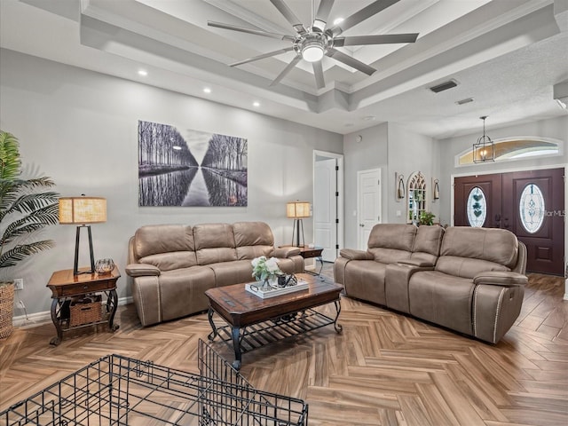 living room with crown molding, parquet floors, ceiling fan, and a tray ceiling