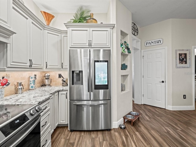 kitchen featuring stainless steel appliances, light stone counters, white cabinets, dark hardwood / wood-style flooring, and decorative backsplash