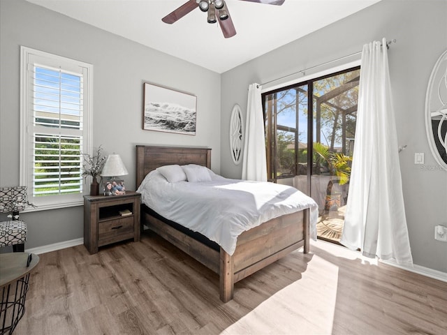 bedroom featuring access to outside, ceiling fan, and light wood-type flooring