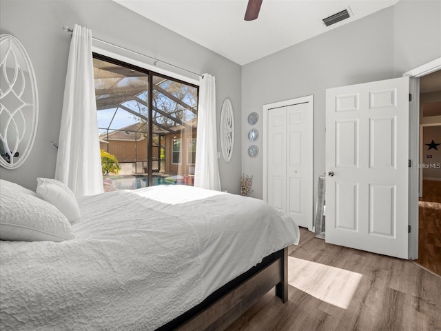 bedroom featuring access to outside, a closet, ceiling fan, and light wood-type flooring