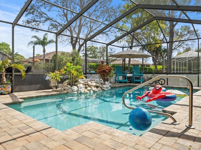 view of swimming pool with a lanai and a patio area