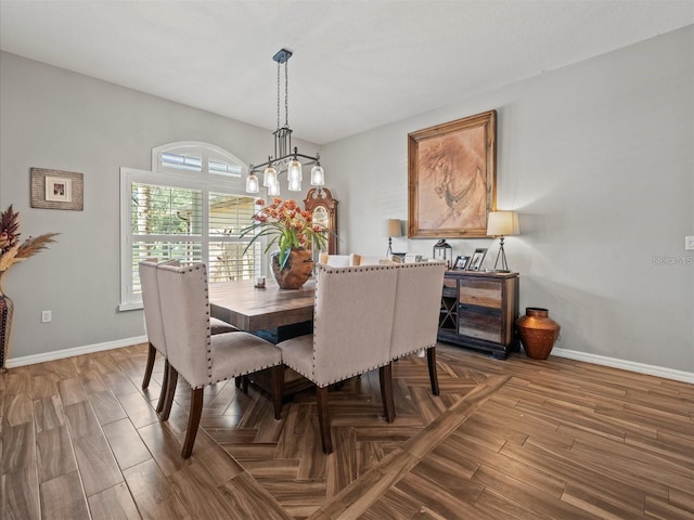 dining room with wood-type flooring and a notable chandelier