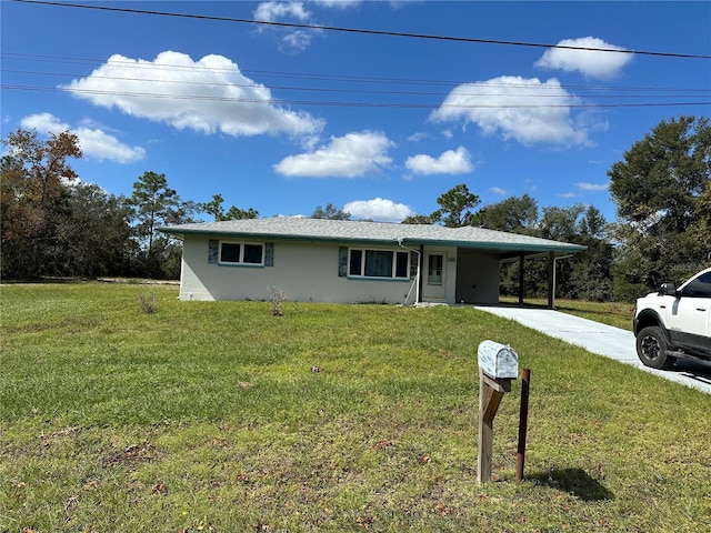 ranch-style home with a carport and a front lawn