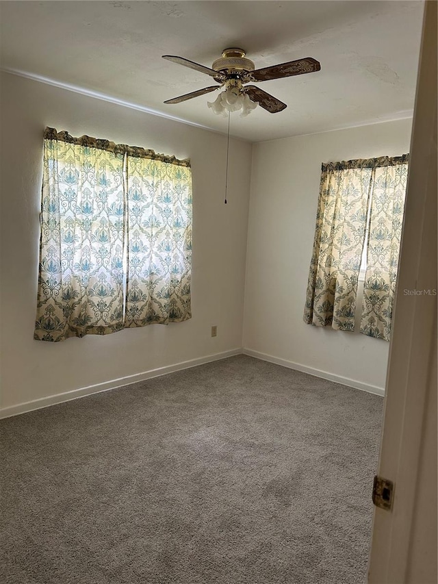 spare room featuring carpet and ceiling fan