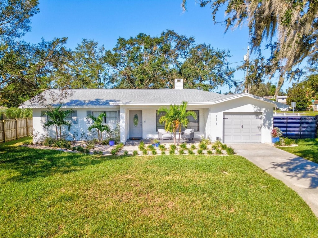 ranch-style house with a front yard and a garage