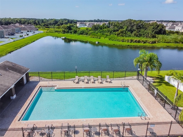 view of pool with a patio and a water view