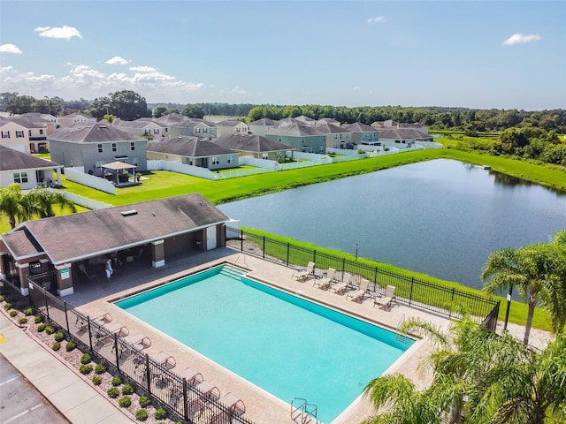 view of swimming pool with a patio and a water view