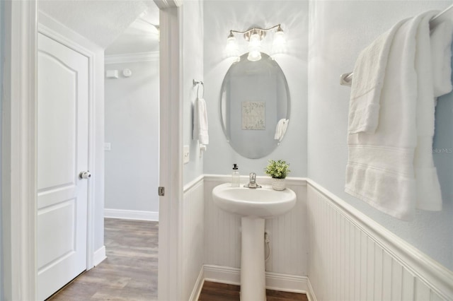 bathroom featuring hardwood / wood-style flooring and crown molding