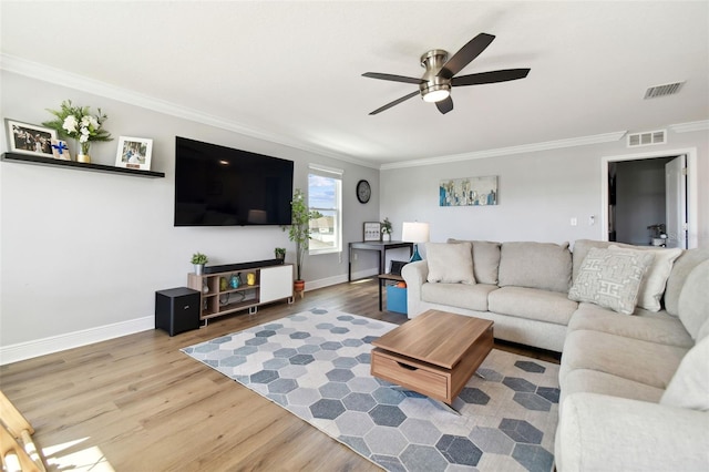 living room featuring ceiling fan, ornamental molding, and hardwood / wood-style floors