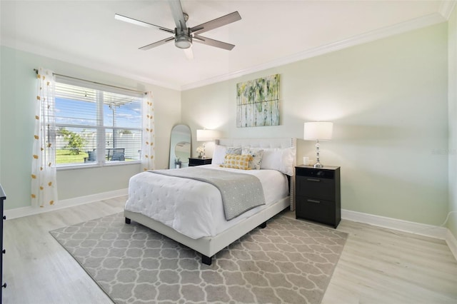 bedroom featuring crown molding, ceiling fan, and light hardwood / wood-style floors