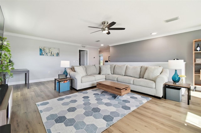 living room featuring crown molding, light hardwood / wood-style floors, and ceiling fan