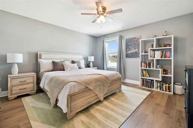 bedroom with wood-type flooring and ceiling fan