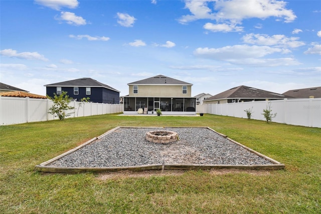 view of yard with an outdoor fire pit and a sunroom