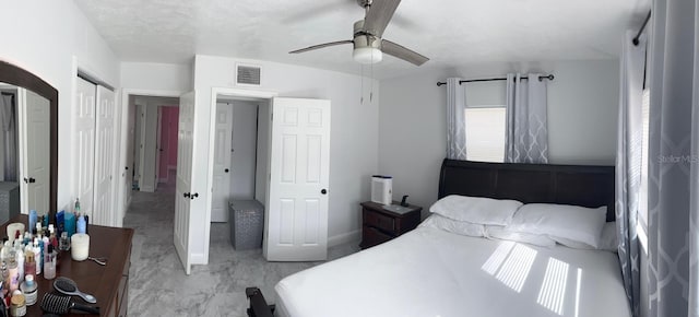 bedroom featuring ceiling fan and a closet