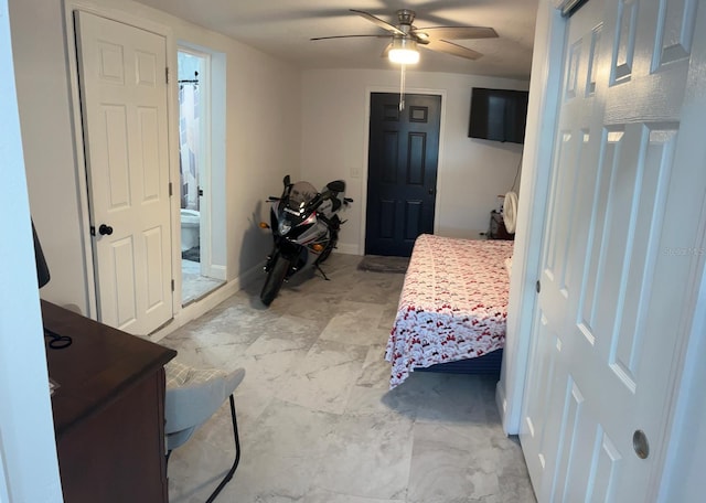 bedroom with ceiling fan and connected bathroom