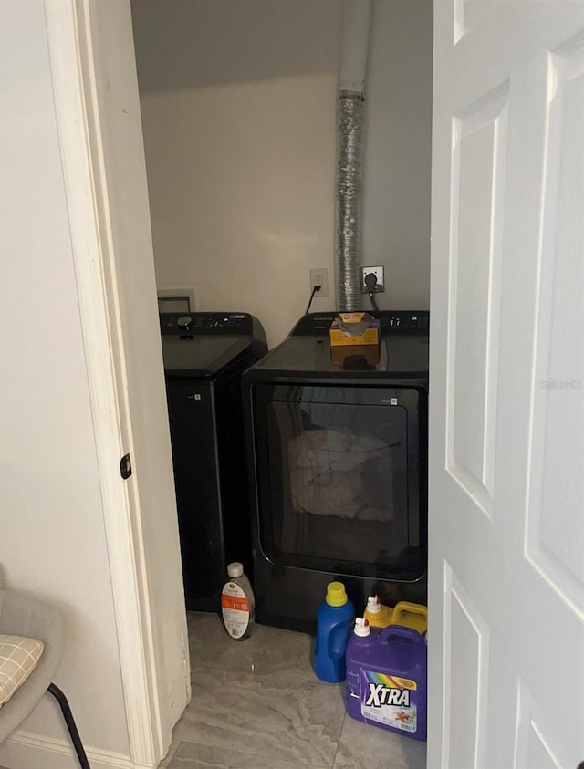 details featuring washer and dryer and wood-type flooring