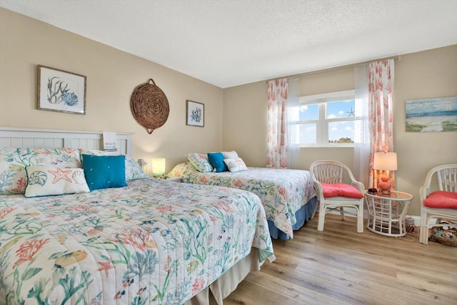 bedroom featuring a textured ceiling and light wood-type flooring