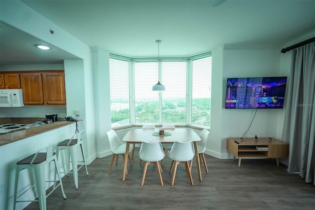 dining area with dark hardwood / wood-style floors