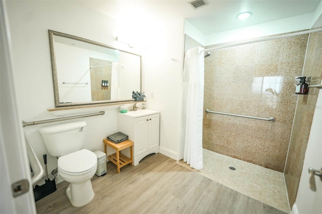 bathroom featuring vanity, wood-type flooring, a shower with curtain, and toilet