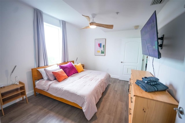 bedroom featuring ceiling fan and dark hardwood / wood-style floors