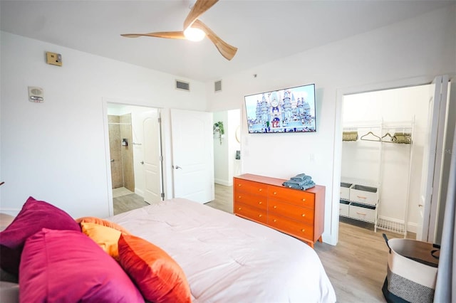 bedroom featuring connected bathroom, light hardwood / wood-style floors, and ceiling fan